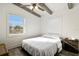 Cozy bedroom featuring wood floors, white walls, and plenty of natural light from two windows at 1817 Mckeown Ave, Haines City, FL 33844