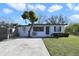 Charming single-story home with a well-manicured lawn and mature trees at 1817 Mckeown Ave, Haines City, FL 33844
