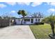 Charming single-story home with well-maintained lawn, mature trees, and a welcoming entrance on a sunny day at 1817 Mckeown Ave, Haines City, FL 33844