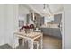 Charming kitchen featuring grey cabinetry, stainless steel appliances, and an adjacent dining area perfect for Gathering meals at 1817 Mckeown Ave, Haines City, FL 33844