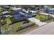 An attractive home featuring a screened-in pool, fenced yard, and a driveway with a fresh, modern aesthetic at 1817 Mckeown Ave, Haines City, FL 33844