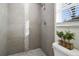 Modern bathroom showcasing tiled shower with decorative accents and natural light from window at 1817 Mckeown Ave, Haines City, FL 33844
