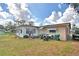 View of backyard showing the exterior of home with an enclosed patio and storage at 20 24Th Sw St, Winter Haven, FL 33880