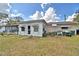 View of backyard showing the exterior of home with an enclosed patio and storage at 20 24Th Sw St, Winter Haven, FL 33880