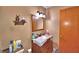 View of the bathroom featuring wooden vanity with sink and decorative lighting at 20 24Th Sw St, Winter Haven, FL 33880