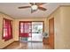 Bonus room with tile flooring, a ceiling fan, and natural light from the windows and sliding doors at 20 24Th Sw St, Winter Haven, FL 33880