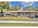 Charming single-story brick home with a well-maintained lawn and a covered porch at 20 24Th Sw St, Winter Haven, FL 33880
