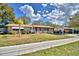 Inviting single-story brick home features a carport and a well-manicured lawn, blending charm with functionality at 20 24Th Sw St, Winter Haven, FL 33880