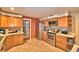 Kitchen features stainless steel appliances, tile backsplash, and wooden cabinets at 20 24Th Sw St, Winter Haven, FL 33880