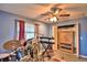 View of a living room featuring modern ceiling fan, tile floors, and music production set up at 20 24Th Sw St, Winter Haven, FL 33880