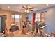 View of a living room featuring modern ceiling fan, tile floors, and set up for music production at 20 24Th Sw St, Winter Haven, FL 33880