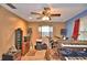 View of a living room featuring modern ceiling fan, tile floors, and music production set up at 20 24Th Sw St, Winter Haven, FL 33880
