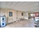 Covered patio with concrete floor and a door leading to the exterior, along with a water heater at 20 24Th Sw St, Winter Haven, FL 33880
