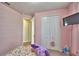 Pink bedroom featuring carpet floors, double door closet, and a wall-mounted television at 200 Summershore Dr, Auburndale, FL 33823