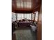 Cozy sunroom-style bedroom with wood-paneled walls and bright natural light at 216 Dorsett Ave, Lake Wales, FL 33853