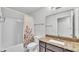 Bathroom featuring granite counters, shower-tub combo and white floral shower curtain at 230 Crescent Ridge Rd, Auburndale, FL 33823