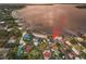 Aerial view of a waterfront home with a beach, dock and lake access at 253 Blackwell Villa Cv, Babson Park, FL 33827