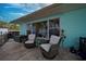 Back patio with two chairs, table and view of the lake at 253 Blackwell Villa Cv, Babson Park, FL 33827