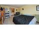 Bedroom with a bed, dresser, and doorway leading to an en-suite bathroom at 253 Blackwell Villa Cv, Babson Park, FL 33827