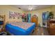 Bedroom featuring wood-look flooring, ceiling fan and closet leading to the bathroom at 253 Blackwell Villa Cv, Babson Park, FL 33827