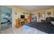 View of a bedroom with a TV, drawers, and doorway leading to the bathroom at 253 Blackwell Villa Cv, Babson Park, FL 33827