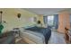 Cozy bedroom with a comfortable bed, window with curtains, and vintage furnishings at 253 Blackwell Villa Cv, Babson Park, FL 33827