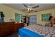 Cozy bedroom with ceiling fan, wood-look flooring and a closet for storage at 253 Blackwell Villa Cv, Babson Park, FL 33827