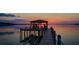 Picturesque dock at sunset features covered area for relaxation and stunning lake views at 253 Blackwell Villa Cv, Babson Park, FL 33827