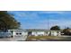 Charming single-story home with bright exterior, solar panels, and a view of the canal at 253 Blackwell Villa Cv, Babson Park, FL 33827