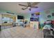 Cozy living room with tile flooring, ceiling fan, and a view of the waterfront patio at 253 Blackwell Villa Cv, Babson Park, FL 33827