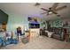 Cozy living room features tile flooring, a ceiling fan and an aquarium at 253 Blackwell Villa Cv, Babson Park, FL 33827