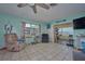 Bright living room with tile floors, a large window, and comfortable seating at 253 Blackwell Villa Cv, Babson Park, FL 33827
