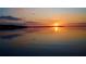 Beautiful sunset over a calm lake, reflecting vibrant oranges and blues across the water at 253 Blackwell Villa Cv, Babson Park, FL 33827