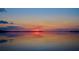 Serene sunset scene with smooth water and colorful sky, perfect for lakeside living at 253 Blackwell Villa Cv, Babson Park, FL 33827