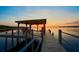 Stunning sunset view of the pier, the lake, and its beautiful reflections at 253 Blackwell Villa Cv, Babson Park, FL 33827