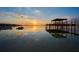Picturesque view of a waterfront featuring a dock and colorful sunset sky at 253 Blackwell Villa Cv, Babson Park, FL 33827