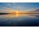 Scenic waterfront view of a calm lake reflecting the sunset sky at 253 Blackwell Villa Cv, Babson Park, FL 33827