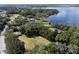 Idyllic aerial view of a lakeside community, showcasing the lush landscape and charming homes near the beautiful lake at 2841 Country Club N Rd, Winter Haven, FL 33881