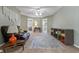 Comfortable living room with a brown leather sofa, neutral walls, and a light-colored carpet at 2841 Country Club N Rd, Winter Haven, FL 33881