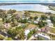 Aerial view of the property with mature trees, a detached garage, and lake view nearby at 309 S 5Th St, Lake Wales, FL 33853