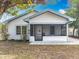 Charming single-story home with a screened front porch and tidy landscaping at 309 S 5Th St, Lake Wales, FL 33853