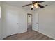 Bedroom with updated flooring, closets, and ceiling fan at 310 Ogden St, Winter Haven, FL 33880