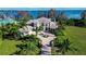 Expansive estate featuring a beautiful home with lush landscaping, circular driveway, and stunning water views at 3312 Eagles Trce, Winter Haven, FL 33884