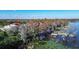 Waterfront property featuring a screened-in pool, private dock, and lush landscaping from above at 3312 Eagles Trce, Winter Haven, FL 33884