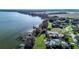 Expansive lakefront property with lush landscaping, private docks, and a screened pool enclosure at 3312 Eagles Trce, Winter Haven, FL 33884