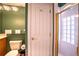 Bathroom featuring a shower with glass block window, modern lighting, and neutral tile surround at 3312 Eagles Trce, Winter Haven, FL 33884