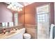 Well-lit bathroom featuring a shower with glass block window and neutral tile surround at 3312 Eagles Trce, Winter Haven, FL 33884