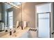 Bright bathroom with a glass shower, black-and-white tile accents, and a large mirror above the vanity at 3312 Eagles Trce, Winter Haven, FL 33884
