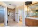 Hallway with bathroom featuring a large vanity, closet, toilet room, and shower at 3312 Eagles Trce, Winter Haven, FL 33884