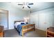 Comfortable bedroom with neutral walls, two closets, and a traditional wooden bed frame at 3312 Eagles Trce, Winter Haven, FL 33884